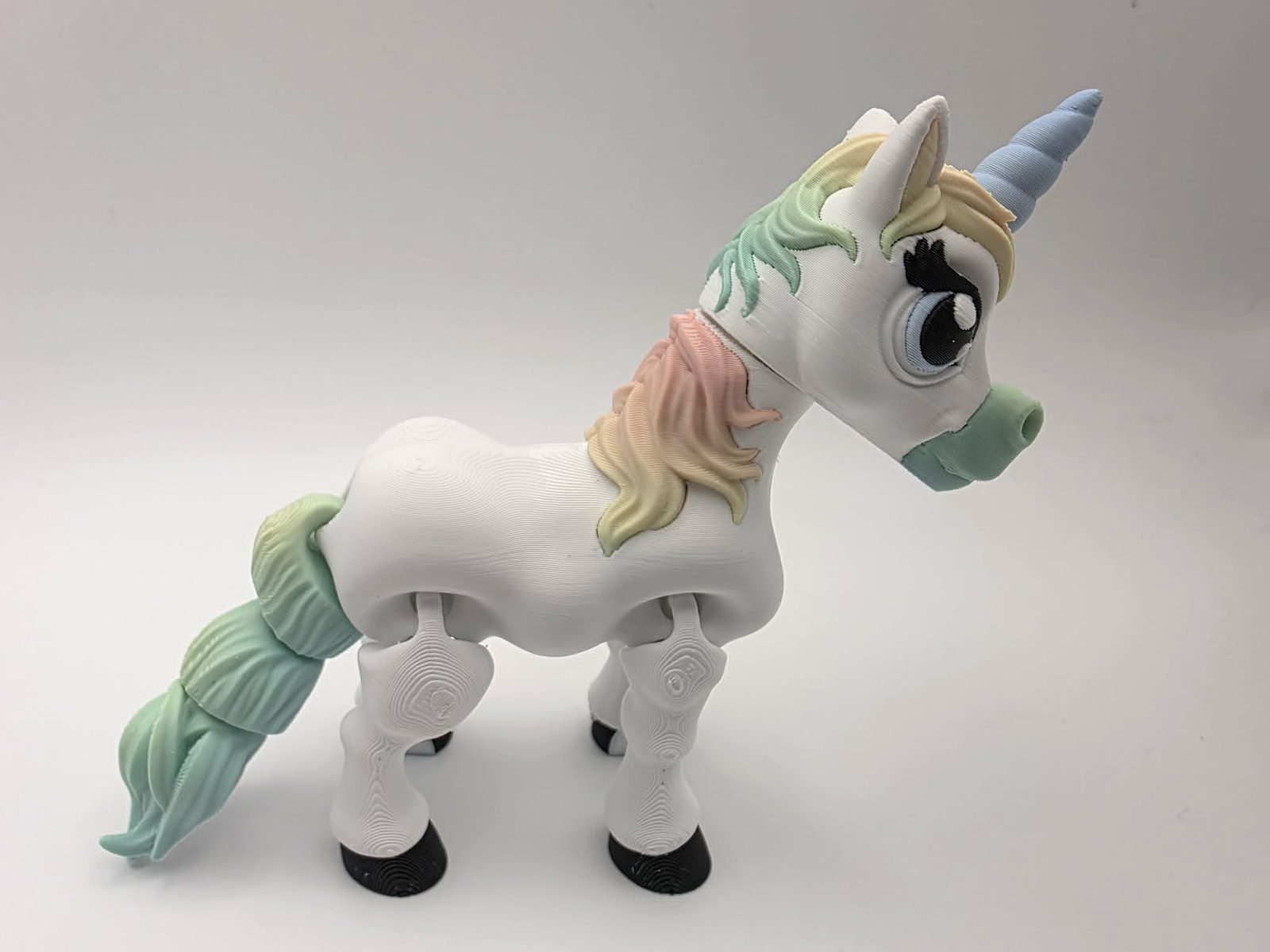 Unicorn - Pastel Dream - 5" Long x 1.5" Wide x 4.25" Tall - White, Matte Rainbow, Black, Blue and White 3D printed item image