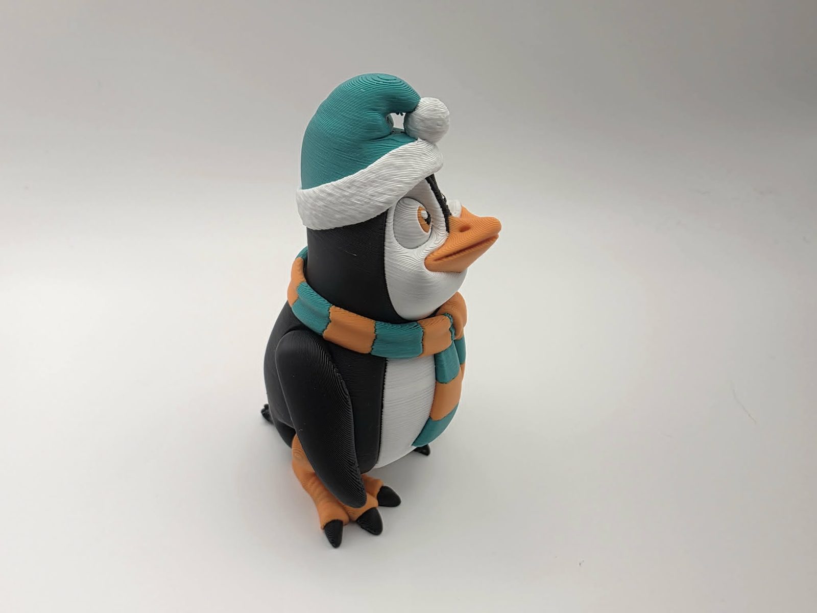 Penguin - Cozy Christmas Waddles - 1.75 Wide x 2.25" Chest to Tail x 3.5" - 4" Tall - Black, White, Mint Green, Sunny Orange 3D printed item image
