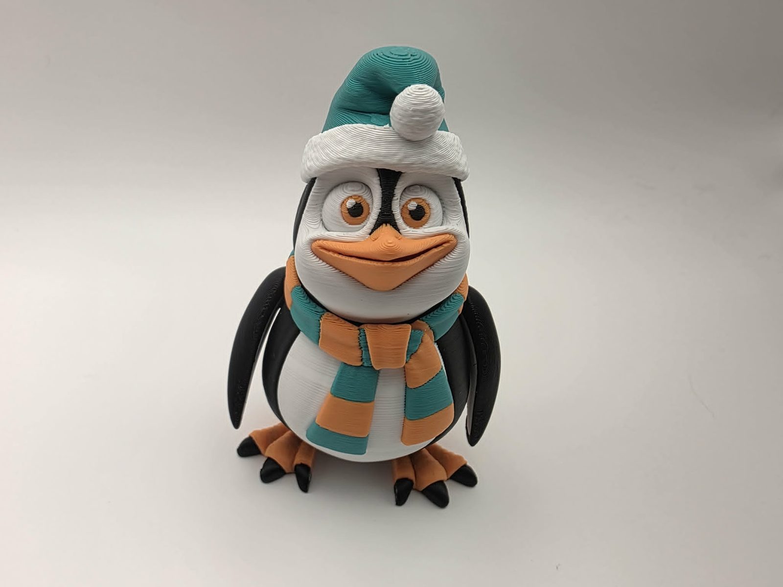 Penguin - Cozy Christmas Waddles - 1.75 Wide x 2.25" Chest to Tail x 3.5" - 4" Tall - Black, White, Mint Green, Sunny Orange 3D printed item image