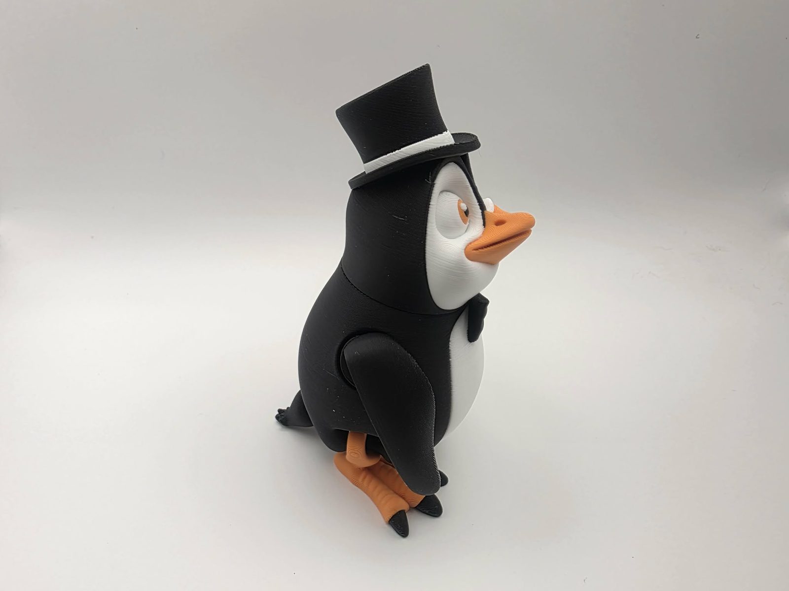 Penguin - Fancy Flipper - 3" Wide x 2.5" Chest to Tail x 4.25" - 5" Tall - Black, White, Sunny Orange 3D printed item image