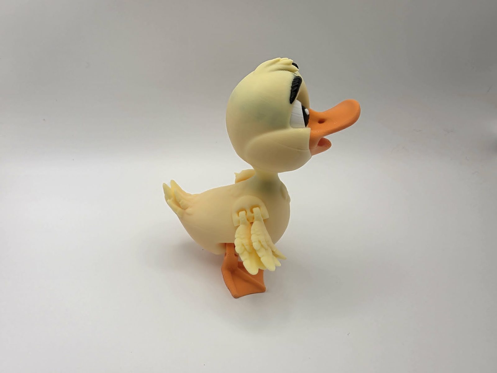 Duck - Daisy Duckling - 3.25" Outer Wing to Outer Wing x 3.5" Wide Wing to Wing x 4.25" Tall - Lemon Yellow, Sunny Orange, Black, White 3D printed item image